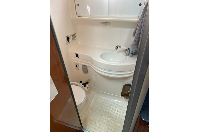 Slide: The Image of Compact bathroom in 2000 Chaparral Signature 300 boat with sink and toilet. - 26