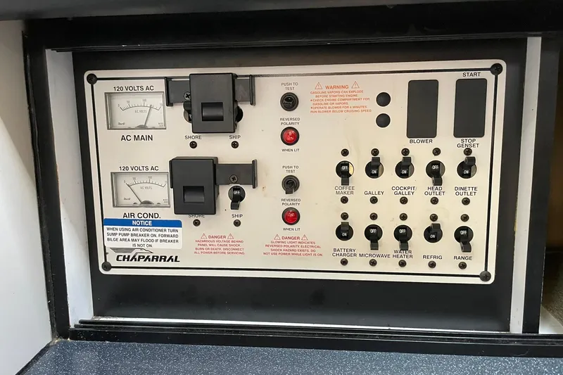 Slide: The Image of Control panel of a 2000 Chaparral Signature 300 boat with various switches and indicators. - 27