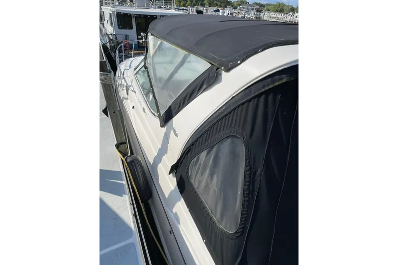 Slide: The Image of 2000 Chaparral Signature 300 boat with black canopy docked at marina. - 5