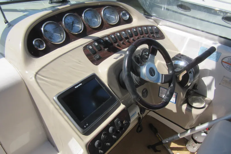 Slide: The Image of Cockpit of 2000 Chaparral Signature 300 boat with steering wheel and control panel. - 6