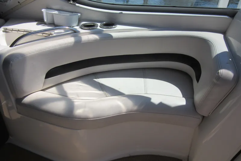 Slide: The Image of 2000 Chaparral Signature 300 boat interior with white leather seating and cup holders. - 9