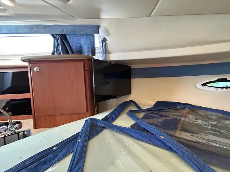 Slide: The Image of Interior of 2007 Bayliner 305 boat with wooden cabinetry and blue accents. - 26