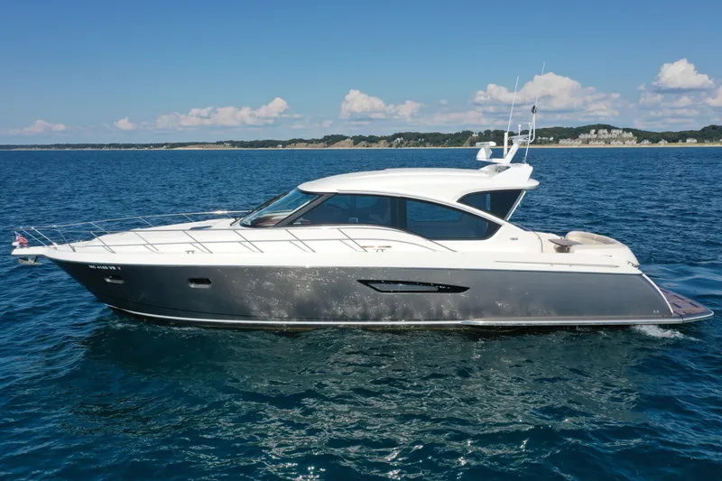 Slide: The Image of 2014 Tiara Yachts 5800 Sovran cruising on open water under clear skies. - 1