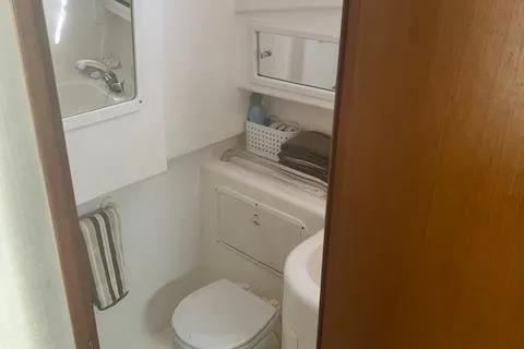 Slide: The Image of 2001 Cabo 31 Express cabin interior with bed, kitchenette, and storage. - 12