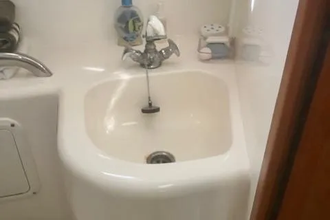 Slide: The Image of 2001 Cabo 31 Express interior with beige leather seating and compact dining table. - 13