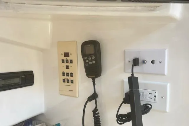 Slide: The Image of Storage compartment in 2001 Cabo 31 Express boat with fishing rods and gear. - 15