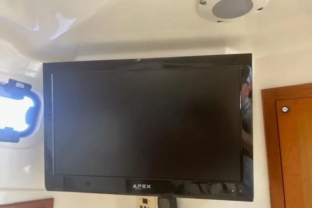 Slide: The Image of Apex TV mounted inside a 2001 Cabo 31 Express boat cabin. - 21