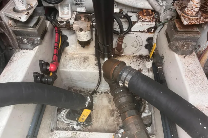 Slide: The Image of Engine compartment of a 2001 Cabo 31 Express boat, showing hoses and mechanical components. - 24