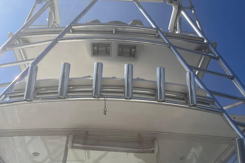 Slide: The Image of 2001 Cabo 31 Express boat docked at marina under clear blue sky. - 5
