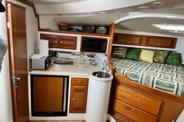 Slide: The Image of 2001 Cabo 31 Express boat interior with seating and fishing rod holders. - 9