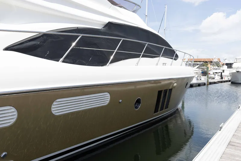 The Image of 2014 Azimut 60 Flybridge yacht docked at marina, side view. - 0