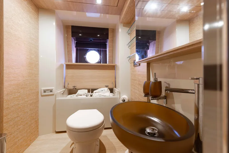Slide: The Image of Luxurious bathroom on 2014 Azimut 60 Flybridge yacht with modern fixtures and porthole window. - 11
