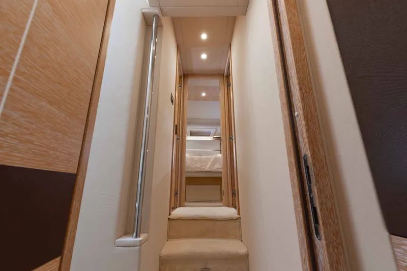 Slide: The Image of Interior hallway of 2014 Azimut 60 Flybridge yacht with wooden accents and soft lighting. - 12