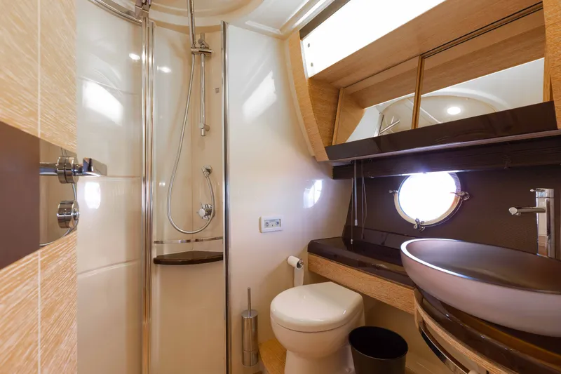 Slide: The Image of Luxurious bathroom in 2014 Azimut 60 Flybridge yacht with modern fixtures and porthole window. - 15