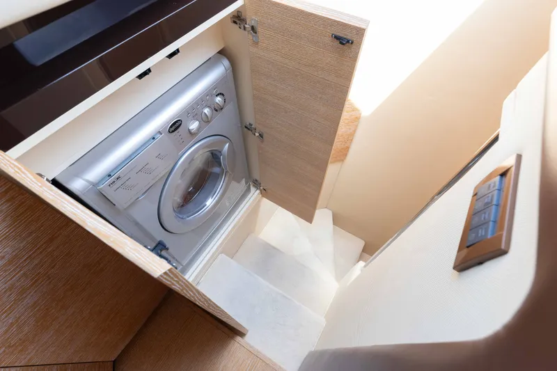 Slide: The Image of Washing machine in 2014 Azimut 60 Flybridge yacht interior, wooden cabinetry. - 21