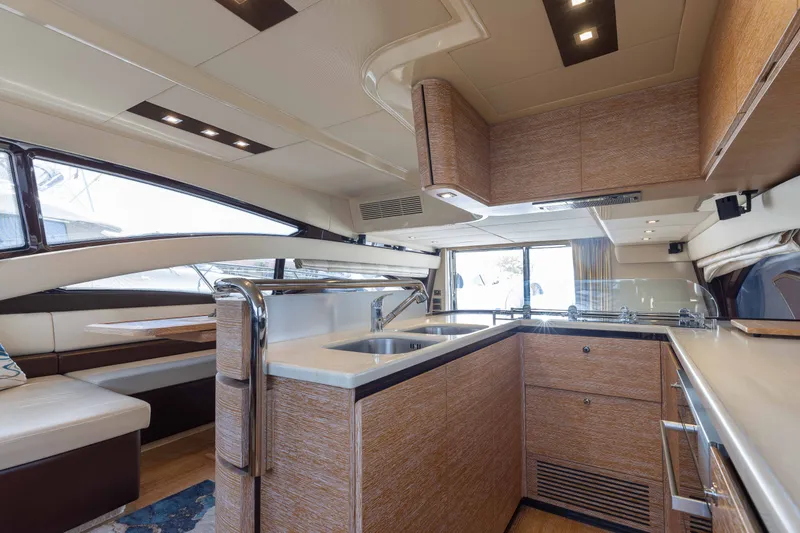 Slide: The Image of Luxurious interior of 2014 Azimut 60 Flybridge yacht with modern kitchen and seating area. - 28