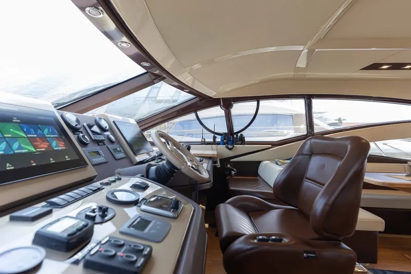 Slide: The Image of Luxurious 2014 Azimut 60 Flybridge yacht interior with modern navigation controls and leather seating. - 32