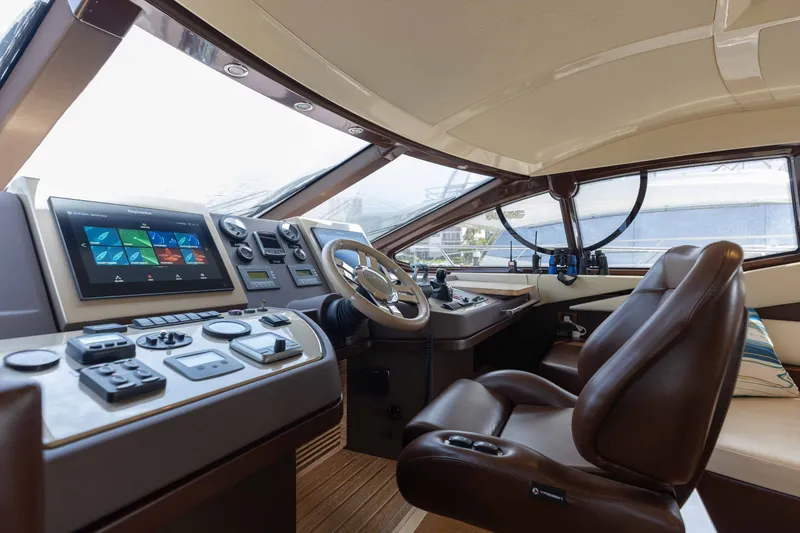 Slide: The Image of Luxurious helm of 2014 Azimut 60 Flybridge yacht with modern controls and leather seating. - 33