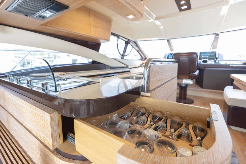 Slide: The Image of Luxurious interior of 2014 Azimut 60 Flybridge yacht with elegant kitchen and glassware drawer. - 42