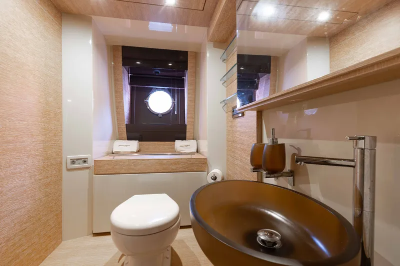 Slide: The Image of Luxurious bathroom in 2014 Azimut 60 Flybridge yacht with modern fixtures and porthole window. - 9