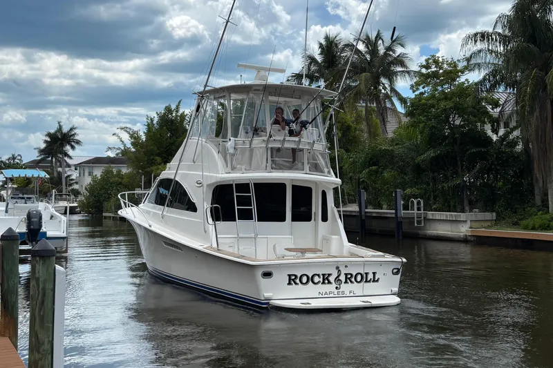 The Image of 2008 Ocean 42 Super Sport Convertible yacht in a scenic canal setting. - 0