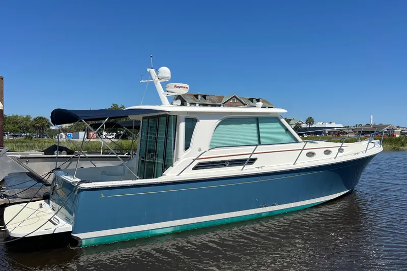 Slide: The Image of 2016 Back Cove 37 boat docked on calm water under clear blue sky. - 10