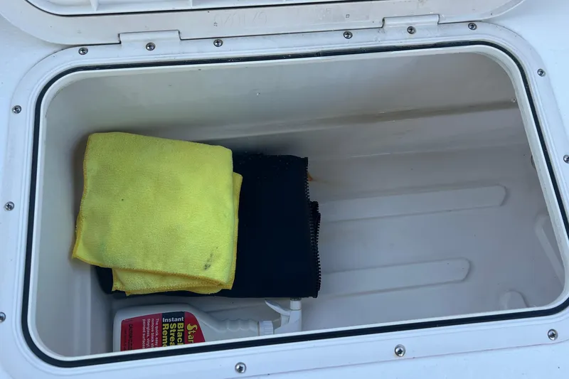 Slide: The Image of Storage compartment on a 2016 Back Cove 37 boat with cleaning supplies. - 11