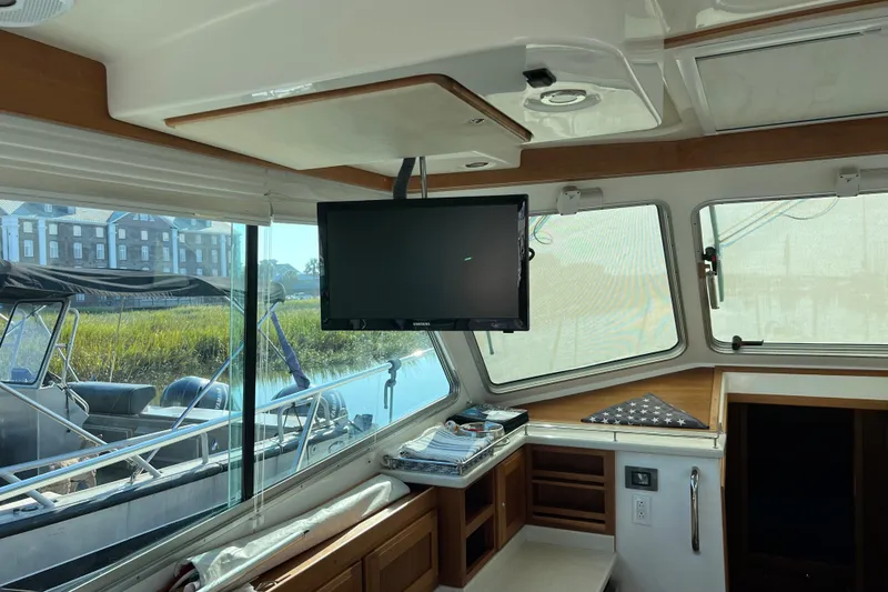 Slide: The Image of Interior of a 2016 Back Cove 37 boat with a mounted TV and scenic window view. - 18