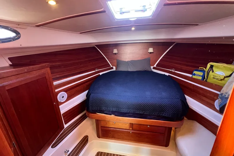 Slide: The Image of 2016 Back Cove 37 boat interior storage compartment with open hatch and visible contents. - 26