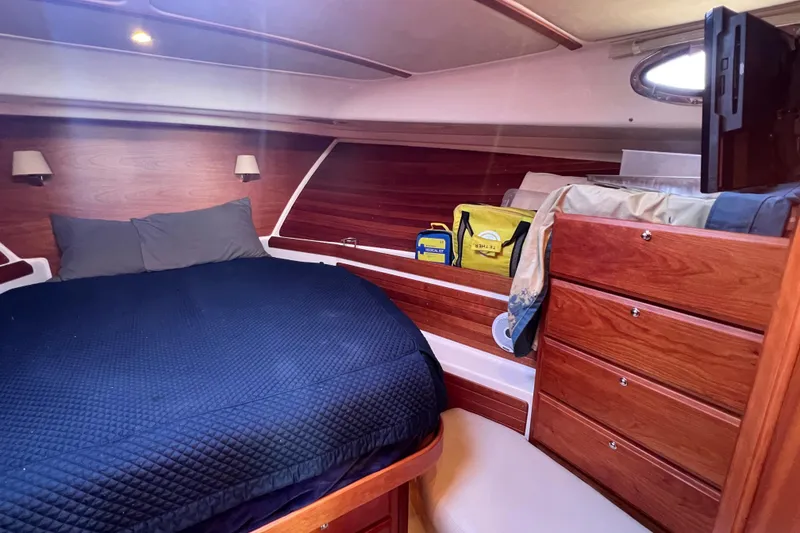 Slide: The Image of Cozy cabin interior of 2016 Back Cove 37 with nautical decor and porthole windows. - 27