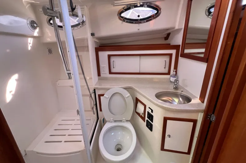 Slide: The Image of 2016 Back Cove 37 interior with wooden cabinetry and porthole window. - 30