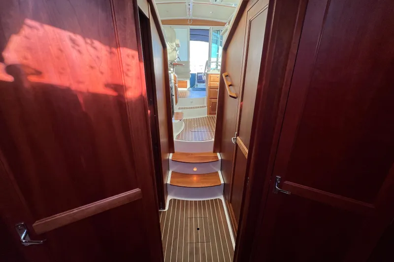Slide: The Image of 2016 Back Cove 37 yacht bathroom with shower, toilet, sink, and storage cabinets. - 31