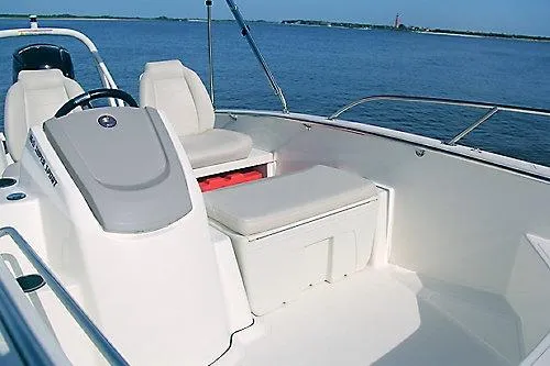 Slide: The Image of 2026 Boston Whaler 160 Super Sport boat interior with seating, on a calm blue sea. - 7