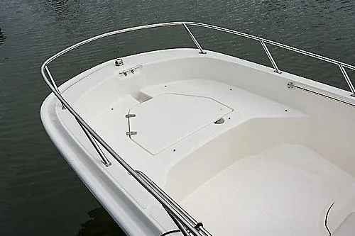 Slide: The Image of 2026 Boston Whaler 160 Super Sport boat deck with railing on calm water. - 9