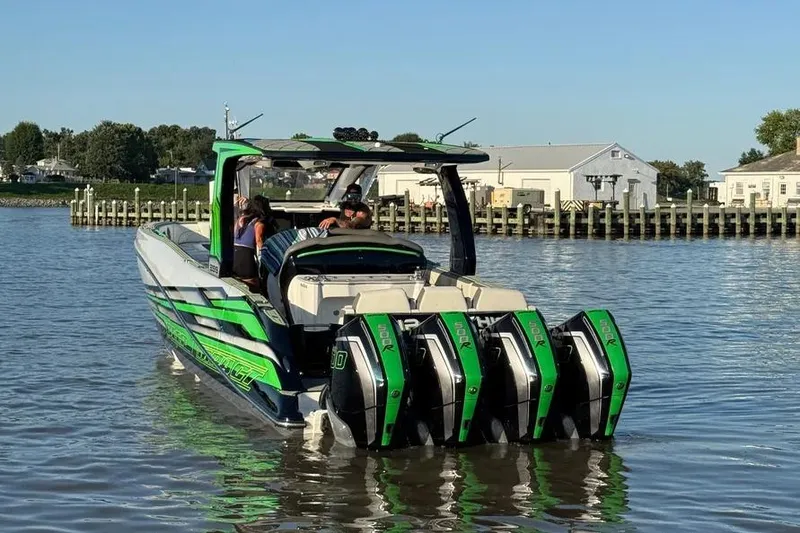 Slide: The Image of 2024 Deep Impact 399 Sport boat with quad engines on calm water. - 3