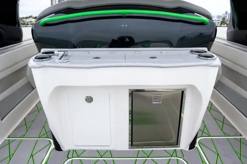 Slide: The Image of 2024 Deep Impact 399 Sport boat interior with sleek countertop and built-in mini fridge. - 7