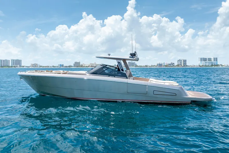 Slide: The Image of 2019 CNM Continental 54 yacht on blue ocean with city skyline background. - 14