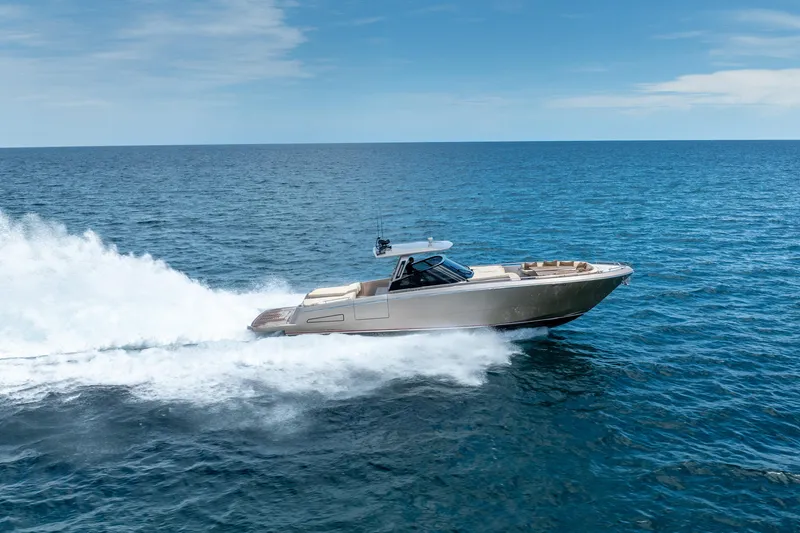 Slide: The Image of 2019 CNM Continental 54 yacht cruising on open sea under clear blue sky. - 7