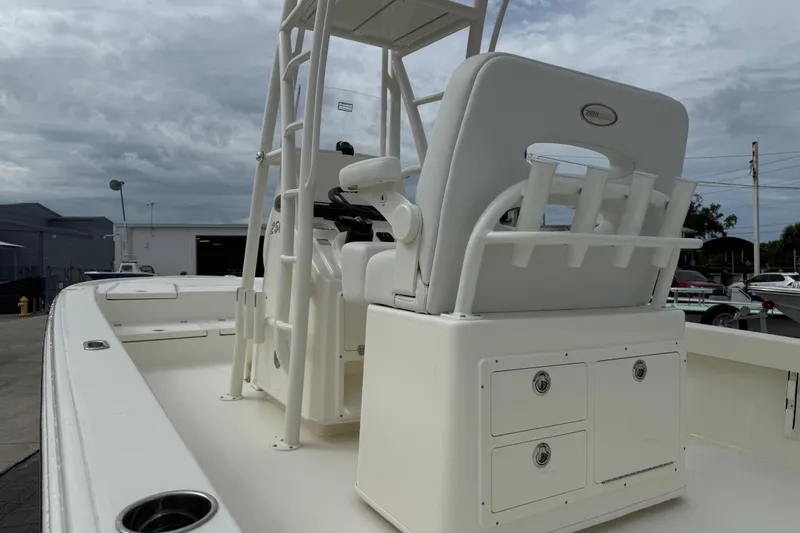 Slide: The Image of 2026 Pathfinder 2500 Hybrid boat interior with seating and storage, under cloudy sky. - 10