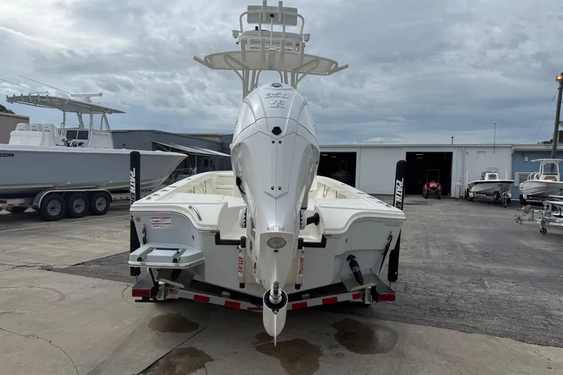 Slide: The Image of 2026 Pathfinder 2500 Hybrid boat on trailer, displayed outdoors at a marina. - 8