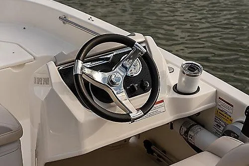 Slide: The Image of 2026 Boston Whaler 130 Super Sport boat steering console with gauges and cup holder. - 6