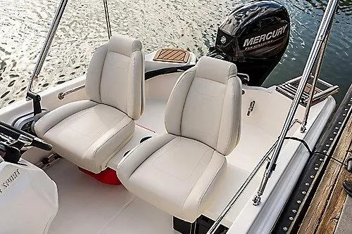 Slide: The Image of 2026 Boston Whaler 130 Super Sport boat interior with two seats and Mercury engine. - 8