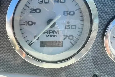 Slide: The Image of Close-up of a 2005 Sea Ray 185 Sport RPM gauge displaying 1195 RPM. - 12