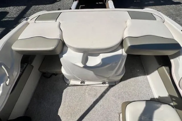 Slide: The Image of 2005 Sea Ray 185 Sport boat interior with cushioned seating and storage compartments. - 5