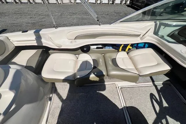 Slide: The Image of Interior of a 2005 Sea Ray 185 Sport boat with beige seating and carpeted floor. - 6