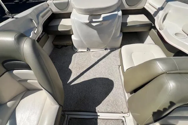 Slide: The Image of Interior of a 2005 Sea Ray 185 Sport boat with beige seating and carpeted floor. - 7