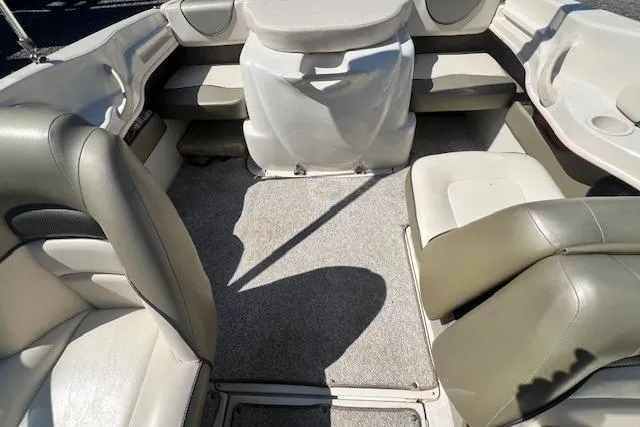 Slide: The Image of 2005 Sea Ray 185 Sport boat interior with beige seating and carpeted floor. - 8
