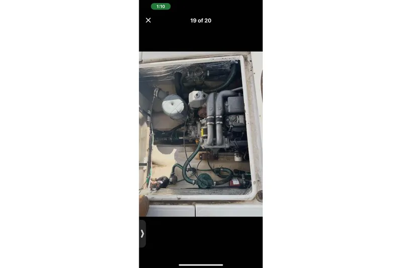 Slide: The Image of Engine compartment of a 2007 Ranger Tugs R-25 boat, showing mechanical components and hoses. - 13