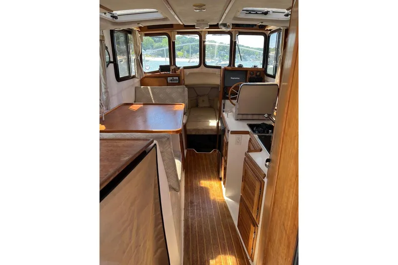 Slide: The Image of Interior of 2007 Ranger Tugs R-25 boat with wood accents and seating area. - 3