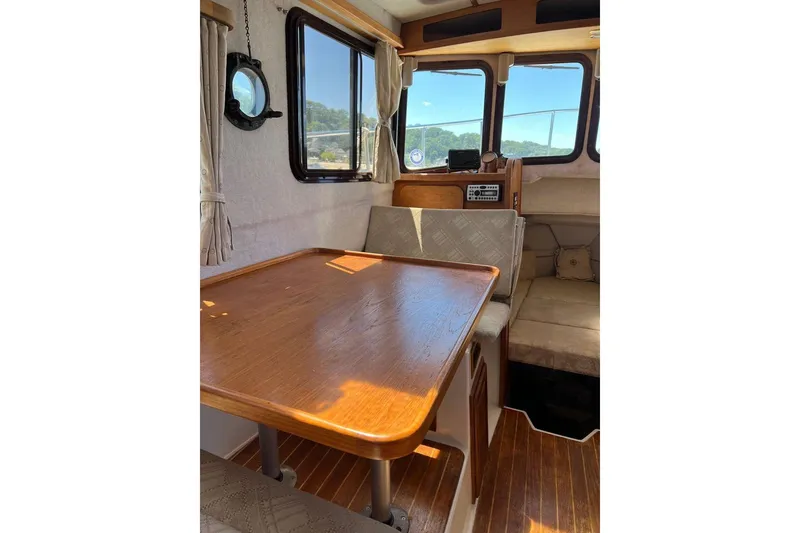 Slide: The Image of Interior of 2007 Ranger Tugs R-25 boat with wooden table and seating area. - 5